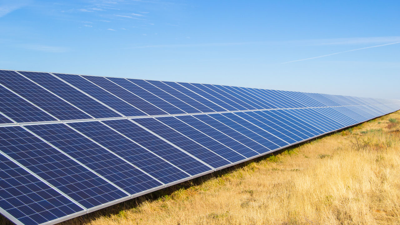 Solar panels in a field of dry grass