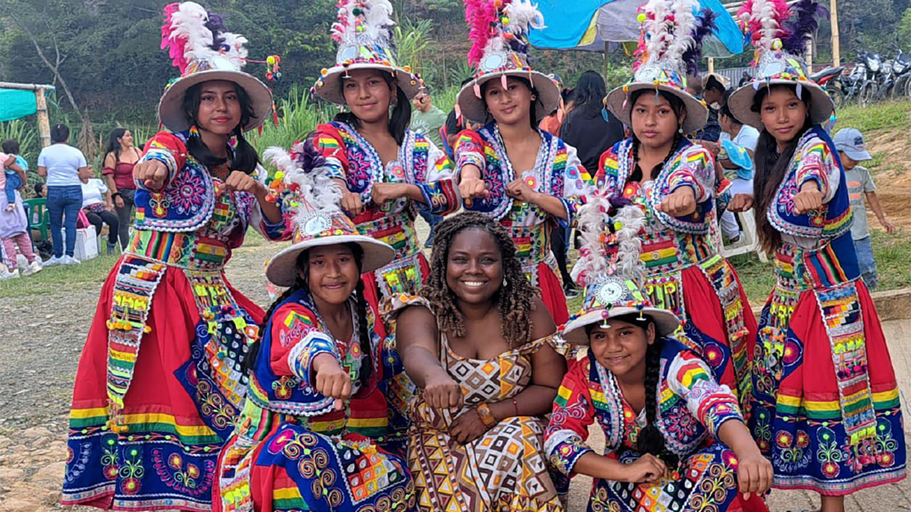 Group of Indigenous women in traditional clothing pose for a group photo at a Generating Equity project event